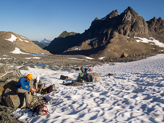 Putting on our crampons at the foot of the White Chuck Glacier.  Baekos Peak in the background.
