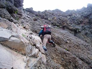 Dad scrambling the summit block of The Husband