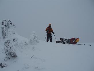 Carla watches Mark take a nap on the summit of Mount Persis