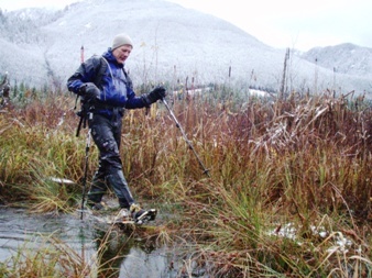 Iron uses his snowshoes to keep from sinking deep into the marshy trail