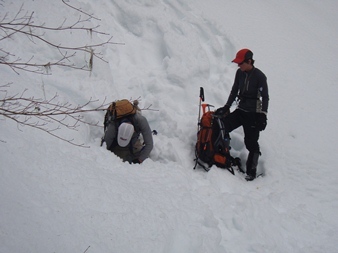 Mike is stuck in a hole and trying to shovel out his snowshoes