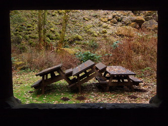 Picnic tables playing outside a CCC shelter at the Hamilton Mountain trail head.