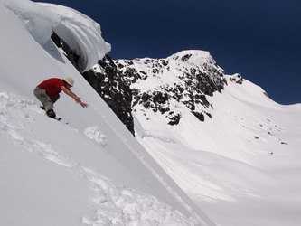 Kevin trundling snowballs down the east side of Davis's south ridge