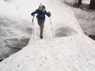 Monique crossing a snow bridge in Commonwealth Basin.