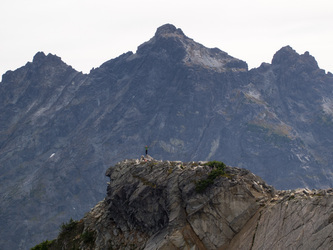 Carla on the summit of Burnt Boot Peak, with Lemah Peak looming in the background.