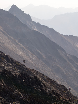 Andrew and Sean with their puppies, RFG 1 and RFG 2 (rock fall generator), approaching the summit of Mount Carru