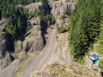 Lindsay looks down at the waterfall basin from the top of the cliff.