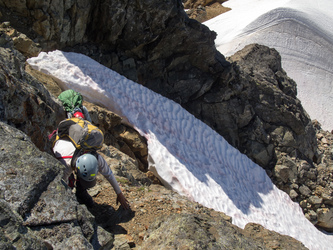 Scrambling up the only difficult terrain on Old Guard, the slabby ramp from the snow finger to the easy class 2 terrain.