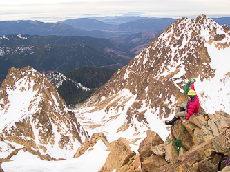 Stefan setting up the rappel.  Point 6136 and Hayden Peak in the background.