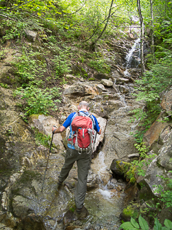 Navigating one of the many stream crossings on the road.