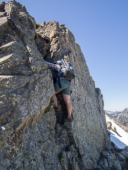 Scrambling the chimney at the start of the rock scramble to the summit.