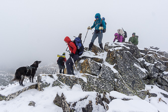 A quick visit on the summit and then it is time to huddle on the lee side out of the wind